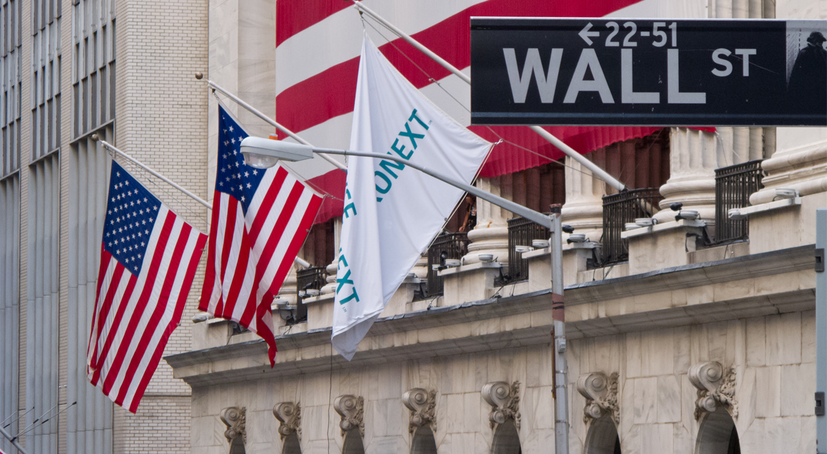 Wall Street with flags on New York Stock Exchange